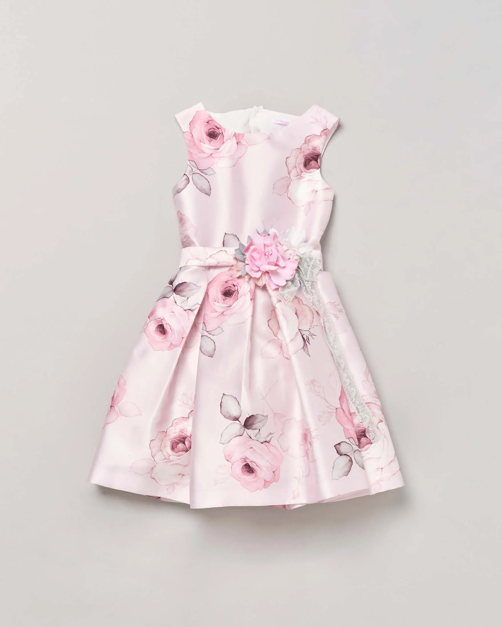 Abito smanicato rosa lucido in fantasia floreale con fascia e applicazione fiore davanti 14 anni